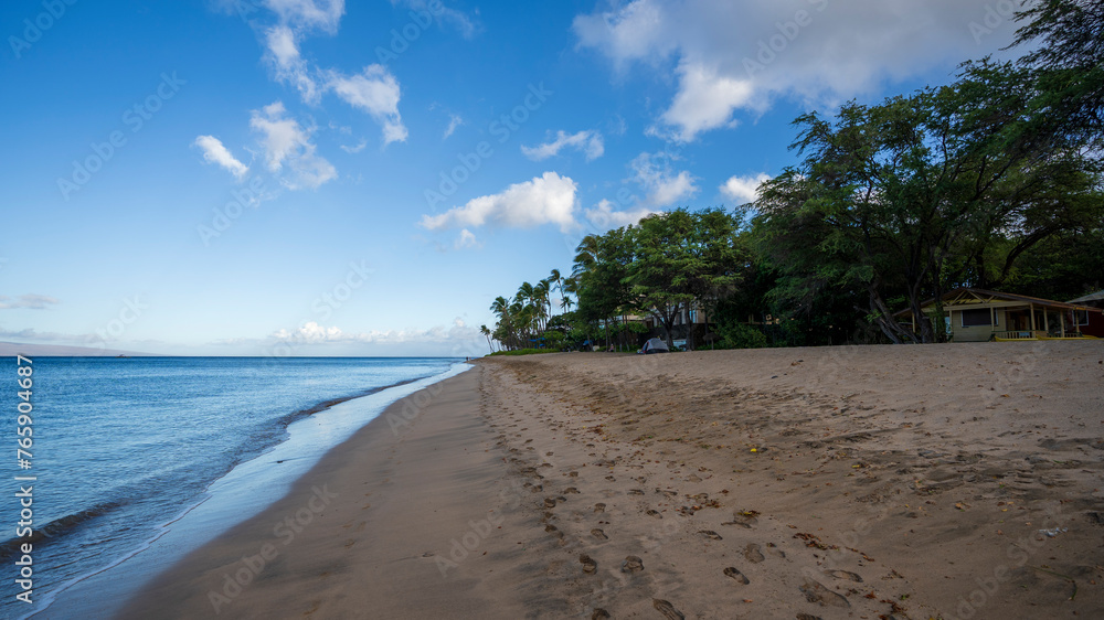 Ocean waves lap the golden shores of Ka'anapali Beach in Lahaina, Hawaii. 