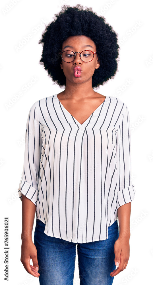 Young african american woman wearing casual clothes and glasses making fish face with lips, crazy and comical gesture. funny expression. Young african american woman wearing casual clothes and glasses making fish face with lips, crazy and comical gesture. funny expression.