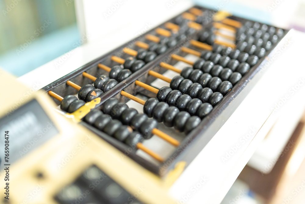 abacus and calculator on the table in the office, business concept abacus and calculator on the table in the office, business concept