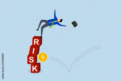 Investment risk, investor falling stack block word RISK effect money coin.