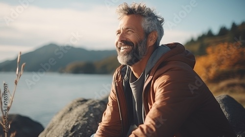 Man Sitting on Rock by Water