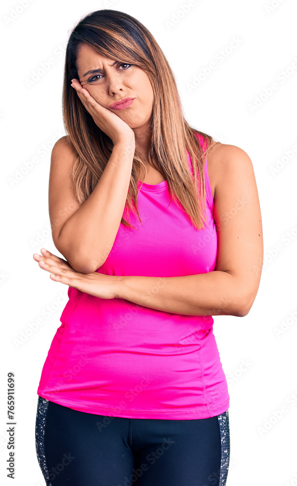 Young beautiful woman wearing sportswear thinking looking tired and bored with depression problems with crossed arms. Young beautiful woman wearing sportswear thinking looking tired and bored with depression problems with crossed arms.