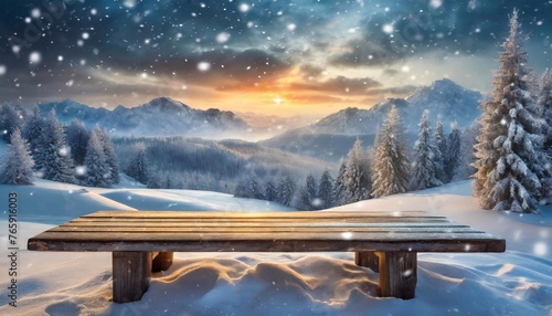 Wooden table on the background of high mountains and snowfall. photo