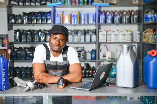 Portrait of a handsome african salesman in an auto parts store. The concept of car repair