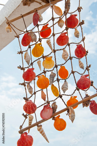 Seashell summer dreamcatcher. Wind chime of sea shell. Seychelles seashell wind chime. Shell dreamcatcher at sea beach. Summer vacation decoration. Sea shell net