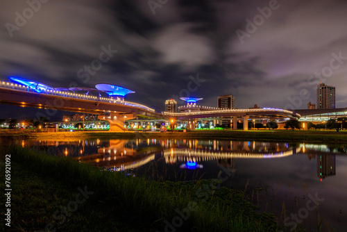 Amazing night scenery and reflections in an early summer evening near the Sanchong Station of Taoyuan Airport MRT in the New Taipei City Metropolitan Park.