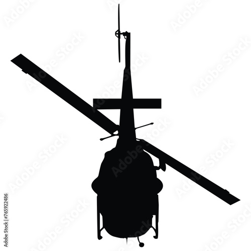 A tail view silhouette of a helicopter in flight