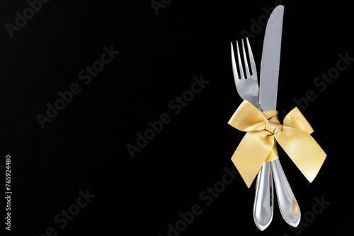 fork and knife with golden ribbon