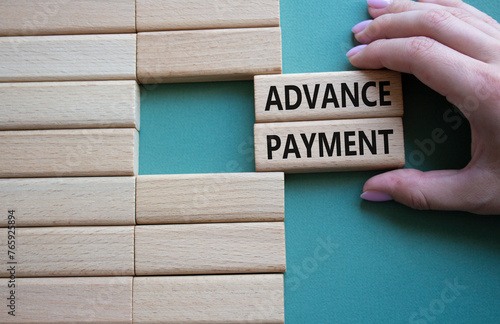 Advance Payment symbol. Concept words Advance Payment on wooden blocks. Businessman hand. Beautiful grey green background. Business and Advance Payment concept. Copy space photo
