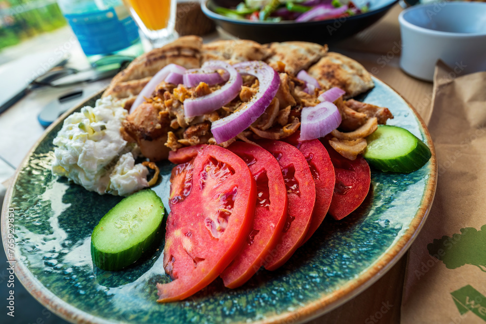 Greek Salad with chicken, cucumber, tomato and onion