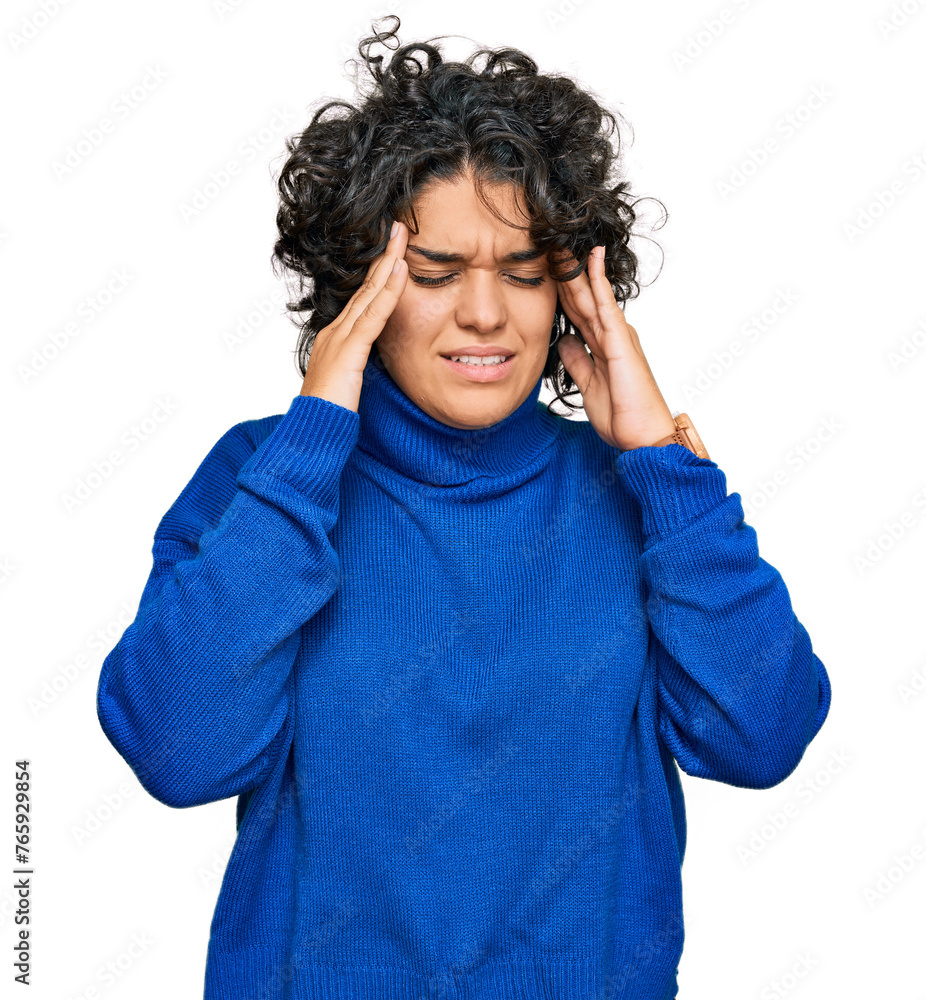 Young hispanic woman with curly hair wearing turtleneck sweater with hand on head, headache because stress. suffering migraine. Young hispanic woman with curly hair wearing turtleneck sweater with hand on head, headache because stress. suffering migraine.