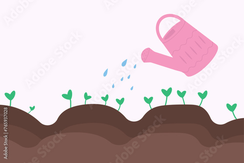 Watering can watering seedlings in the garden