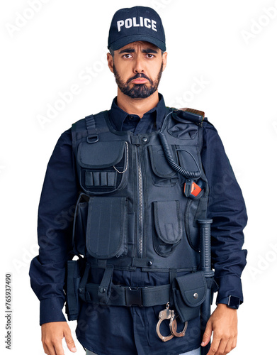 Young hispanic man wearing police uniform depressed and worry for distress, crying angry and afraid. sad expression.