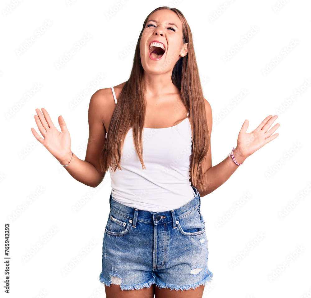 Young beautiful hispanic woman wearing casual clothes crazy and mad shouting and yelling with aggressive expression and arms raised. frustration concept. Young beautiful hispanic woman wearing casual clothes crazy and mad shouting and yelling with aggressive expression and arms raised. frustration concept.