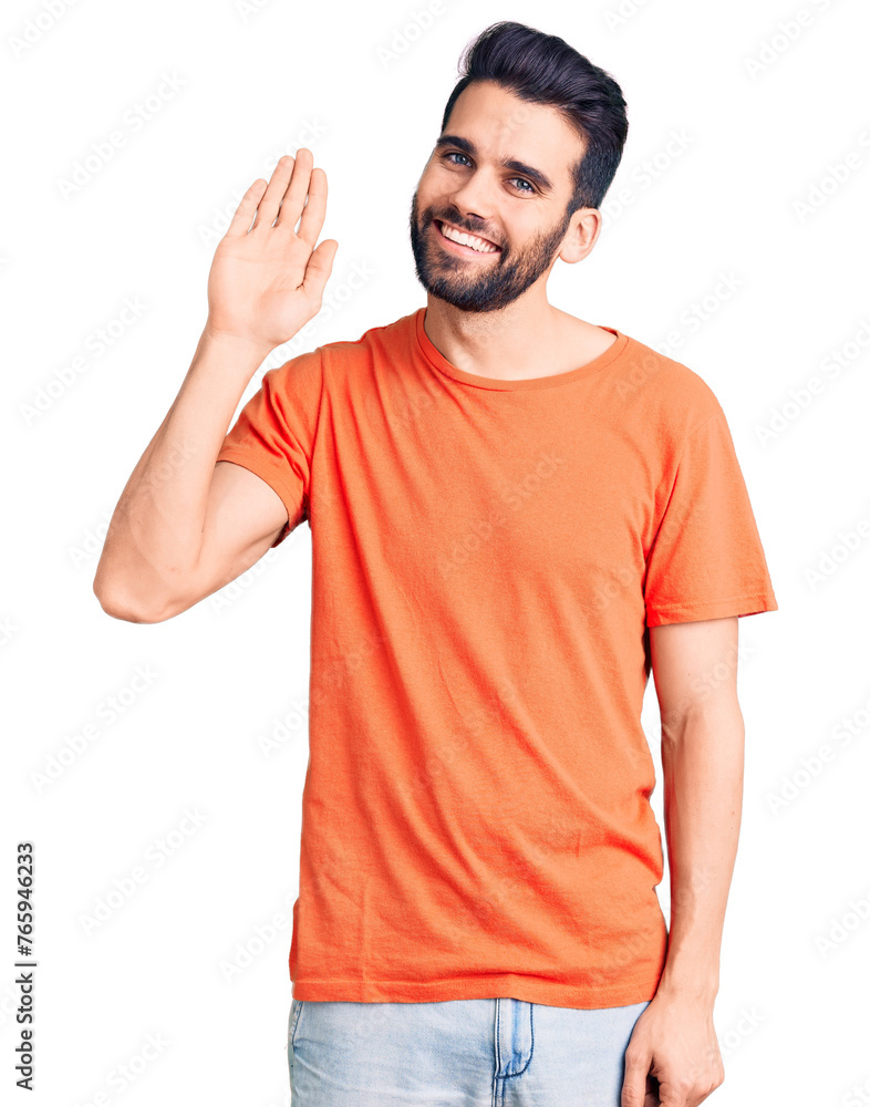 Young handsome man with beard wearing casual t-shirt waiving saying hello happy and smiling, friendly welcome gesture Young handsome man with beard wearing casual t-shirt waiving saying hello happy and smiling, friendly welcome gesture