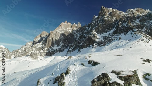Drone flying over sharp snowy mountain peaks in Chamonix France