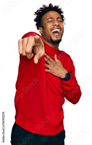 Young african american man with beard wearing casual winter sweater laughing at you, pointing finger to the camera with hand over body, shame expression