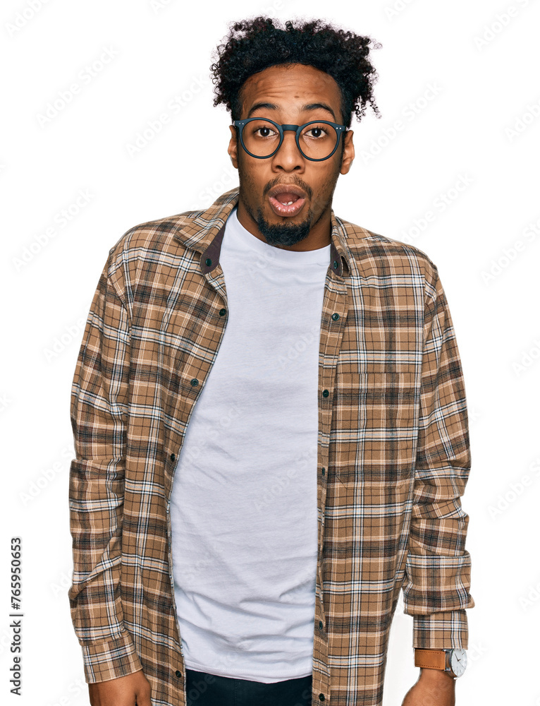 Young african american man with beard wearing casual clothes and glasses afraid and shocked with surprise and amazed expression, fear and excited face. Young african american man with beard wearing casual clothes and glasses afraid and shocked with surprise and amazed expression, fear and excited face.