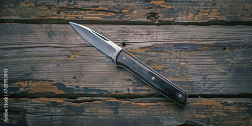 Rustic Elegance: A Knife on Weathered Wood photo