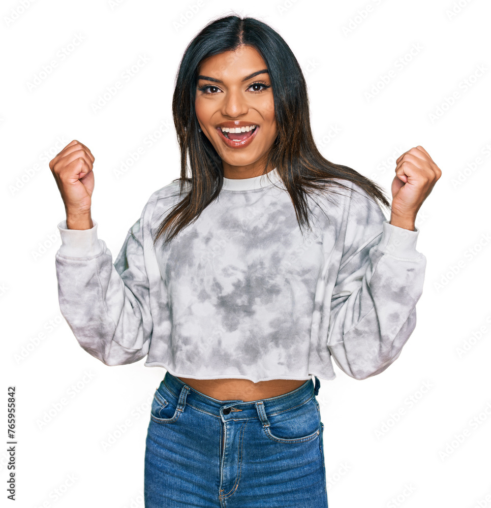 Young latin transsexual transgender woman wearing casual clothes celebrating surprised and amazed for success with arms raised and open eyes. winner concept. Young latin transsexual transgender woman wearing casual clothes celebrating surprised and amazed for success with arms raised and open eyes. winner concept.
