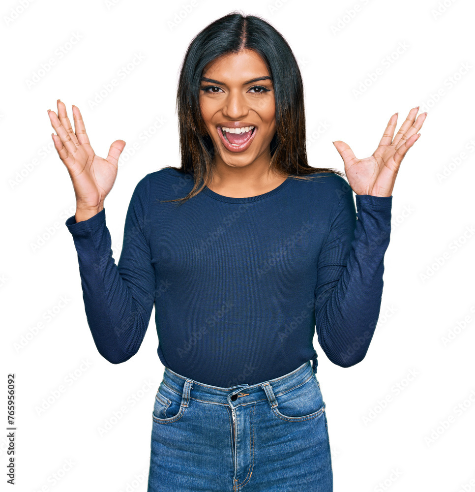 Young latin transsexual transgender woman wearing casual clothes celebrating victory with happy smile and winner expression with raised hands Young latin transsexual transgender woman wearing casual clothes celebrating victory with happy smile and winner expression with raised hands