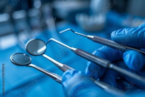 Precision dental instruments in blue gloves  focus on dental health and hygiene. Macro shot of a dentist s hands in blue surgical gloves holding stainless steel dental instruments on a blurred