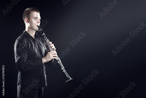 Clarinet player classical musician portrait. Clarinetist playing woodwind instrument