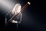 Bassoon woodwind instruments player. Classical musician woman playing orchestral bass