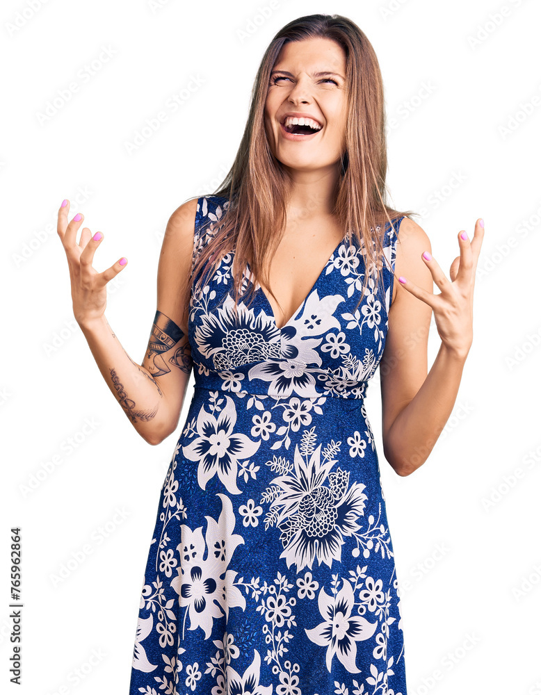 Beautiful caucasian woman wearing summer dress crazy and mad shouting and yelling with aggressive expression and arms raised. frustration concept. Beautiful caucasian woman wearing summer dress crazy and mad shouting and yelling with aggressive expression and arms raised. frustration concept.