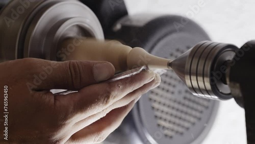 Master Carpenter Turning a Wooden Piece for an Artisan Woodworking Project