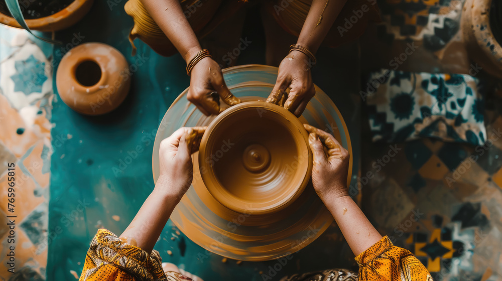 top view of hands making a clay pot on a potter's wheel, craft, hobby, workshop, studio, handmade, ceramics, craft, creativity, person, artist, sculptor, potter - obrazy, fototapety, plakaty 