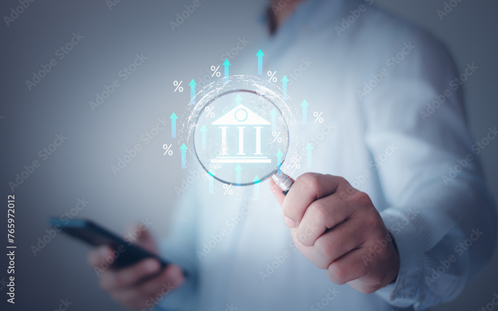 Hand holding magnifying glass focus a debt rate with an increase percent icon, debt increase, interest burden, interest rate rise, federal reserve or central bank raising policy, monetary percentage. Hand holding magnifying glass focus a debt rate with an increase percent icon, debt increase, interest burden, interest rate rise, federal reserve or central bank raising policy, monetary percentage.