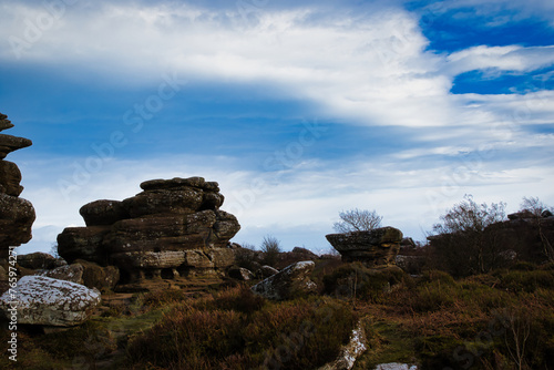 Scenic view of rugged rock formations amidst wild heath under a cloudy sky at Brimham Rocks, in North Yorkshire © Vas