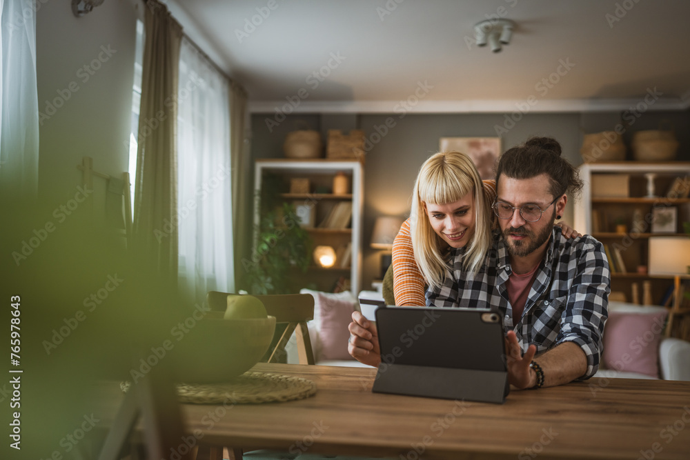 adult happy couple man and woman shopping online hold credit card adult happy couple man and woman shopping online hold credit card