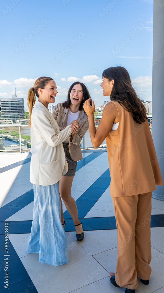 Three radiant women share a moment of joy, their laughter and smiles illuminaties the scene. Three radiant women share a moment of joy, their laughter and smiles illuminaties the scene.