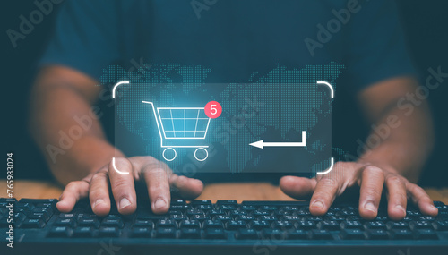 Ecommerce and online shopping concept, Businessman use computer for online shopping on internet network and select product to shopping cart. Global network online marketplace. photo