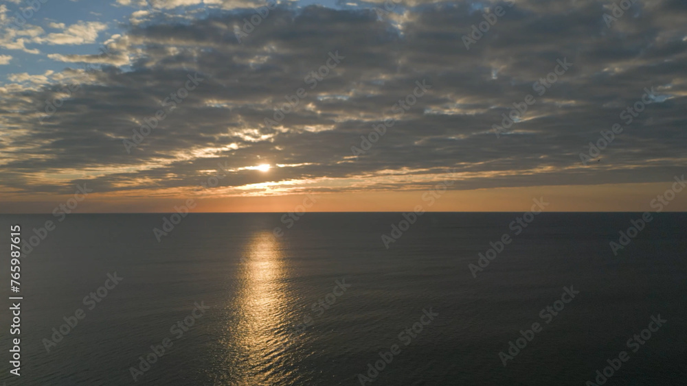 Partly cloudy sunrise over the Atlantic ocean in South Carolina Partly cloudy sunrise over the Atlantic ocean in South Carolina