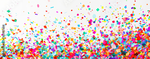 Colorful confetti in flying in the air on a white background.