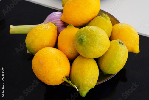 Bowl of fresh lemons with a head of garlic © eqroy