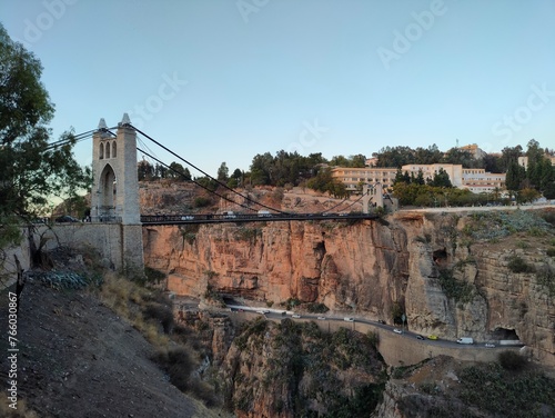 the famous suspension bridge, or footbridge of Sidi M Cid and the road which crosses the caves below at sunset, this bridge crosses the gorges at 175 meters above the Rhumel. Constantine, Algeria photo