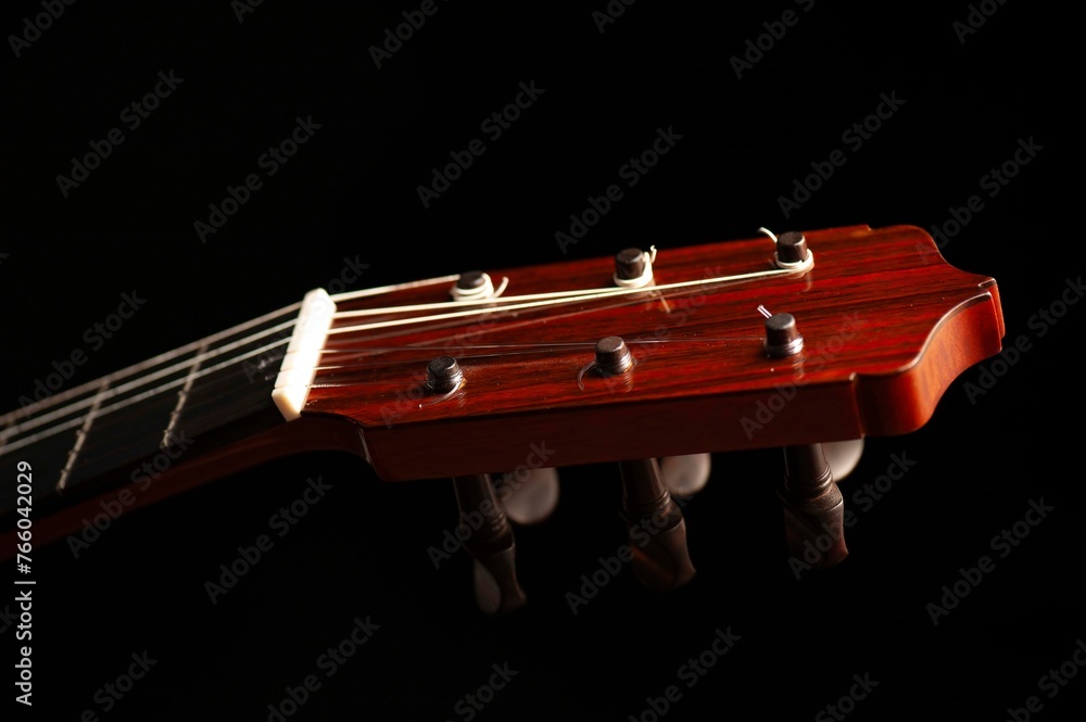 Classical Spanish flamenco guitar close up, dramatically lit isolated on black background with copy space. Classical Spanish flamenco guitar close up, dramatically lit isolated on black background with copy space.