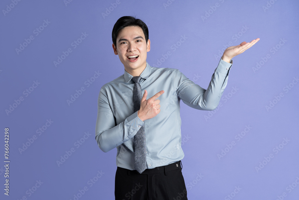 Portrait of Asian male businessman posing on purple background Portrait of Asian male businessman posing on purple background