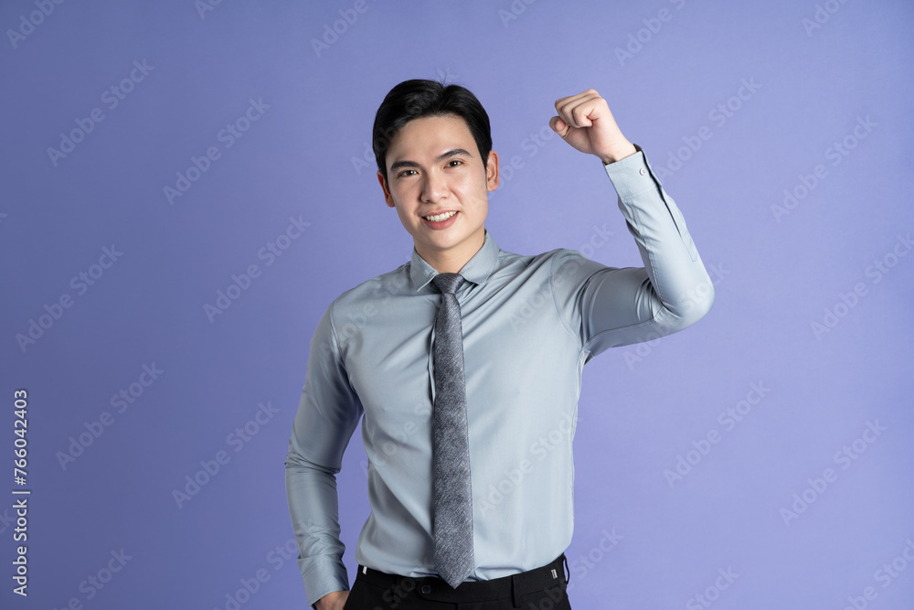 Portrait of Asian male businessman posing on purple background Portrait of Asian male businessman posing on purple background