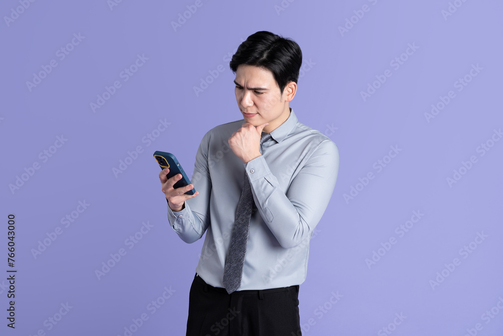 Portrait of Asian male businessman posing on purple background Portrait of Asian male businessman posing on purple background