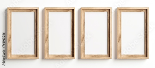 Four picture frames, made of wood and metal, are arranged in a row on a white wall. Each frame is a rectangle with glass, showcasing unique art pieces © 2rogan