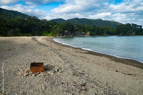 Campfire and on stoney shoreline. Maraehako Bay, Bay of Plenty, New Zealand. photo