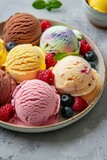 Assorted scoops of colorful ice cream with berries on a plate