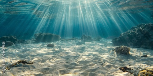 Underwater Sunlight Rays on Sandy Ocean Floor photo
