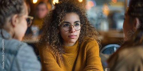 portrait of an attractive young woman with glasses, curly hair and wearing a mustard sweater, generative AI © VALUEINVESTOR