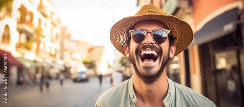 A man with a hat and sunglasses is chuckling while walking on a bustling city street, showcasing his stylish eyewear and sun hat photo